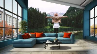 Girl enjoying nature looking at mountain lake in Slovenia, Europe. Wall mural