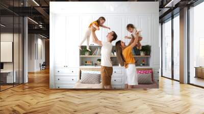 Caucasian family with two children hands in air Wall mural