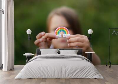 Colorful rainbow in children's hands, a child holds a rainbow in his hands, the concept of LGBT and freedom Wall mural