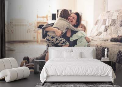 happy mom with two children on the floor in room Wall mural