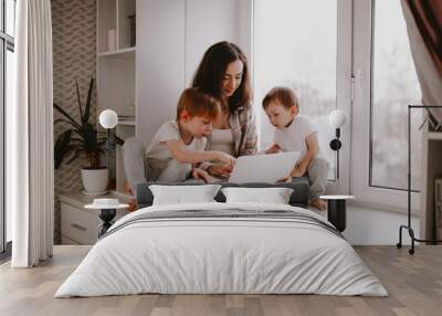 mother with children with laptop online shopping Wall mural