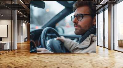 European male business car driver .. A successful young man is behind the wheel. Wall mural