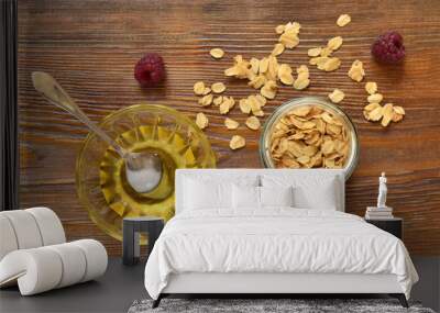 Fresh granola, muesli in glass jar, honey  for heathy breakfast, top view Wall mural