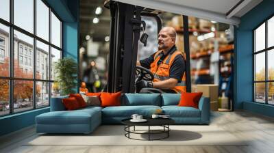 Man worker at forklift driver happy working in industry factory logistic ship. Man forklift driver in warehouse area. Forklift driver sitting in vehicle in warehouse Wall mural