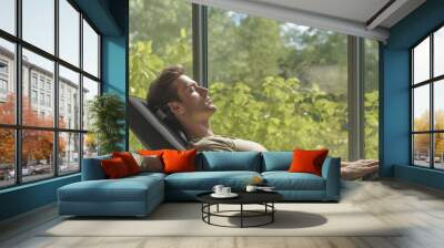 Person takes a break after prolonged computer work. Relaxation after Screen Apnea, window with a view of nature or green space. Banner Wall mural