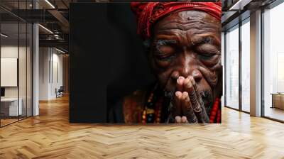 praying to god with hands together Caribbean man praying with black background stock photo Wall mural