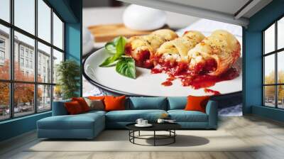 Pasta stuffed with cheese and fish in tomato sauce. Wall mural