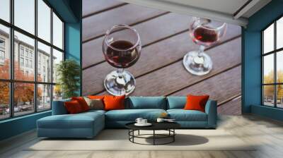 Two glasses of red wine in wooden table. Elegant wine party. Alcoholic drinks. Summer relax with wine. Romance concept. Vineyard in provence. Red wine concept. Wine for two. Lifestyle concept. Wall mural