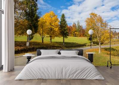 Curved road in the countryside on a bright sunny autumn day Wall mural