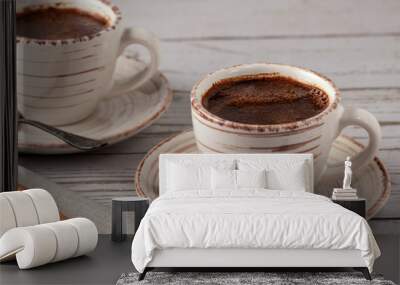 Two cups of aromatic coffee on an old white wooden table. Wall mural