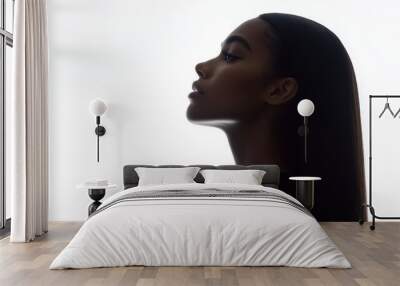 A African American woman with long hair is standing in front of a white background. The image has a moody and mysterious feel to it, as the woman's face is partially obscured by her hair Wall mural