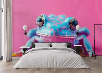 A frog with red eyes stands on a pink background. The frog is green and blue with orange spots. Creative animal concept, macro shot of poisonous frog over pastel bright background Wall mural