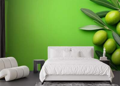 A green background with a bunch of green olives on it. The olives are arranged in a way that they look like they are growing out of the green background Wall mural