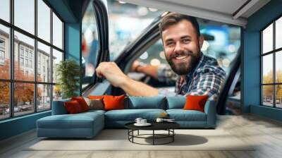 A man with a beard. The car is parked in a showroom. happy fun man customer male buyer client wearing shirt open door get into black car choose auto in showroom. Sales concept photography Wall mural