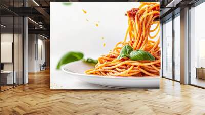 A plate of spaghetti with a fork in it. The spaghetti is covered in sauce and topped with basil Wall mural