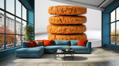 A stack of four cookies on a white plate. The cookies are brown and appear to be homemade Wall mural