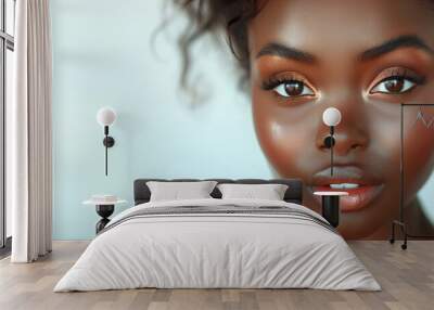 A woman with dark hair and brown eyes is wearing makeup. She has a smile on her face. closed up of plain look beautiful black african women touching her face without cosmetic on white background Wall mural