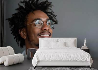 man with glasses and a beard. Laughing expression natural face smile side away looking background. man scientist doctor american Afro black young adult african curly psychologist counselor healer Wall mural