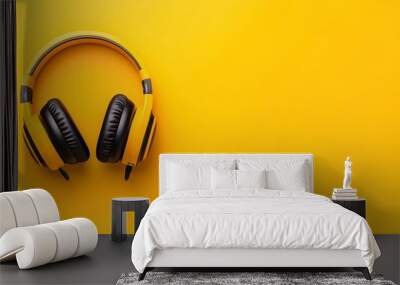 Pair of yellow headphones on a yellow background. The headphones are placed on the yellow background, home page graphics for a web radio site for sales outlets and commercial activities Wall mural