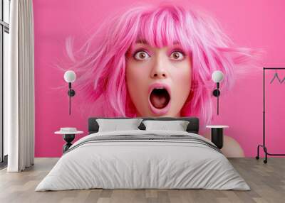 Portrait of a beautiful excited young woman with pink hair on a pink background. Suprised woman with a pink hair. Shocked girl portrait. Believing in Shock. Amazed Young Woman with Pink Hair Staring  Wall mural