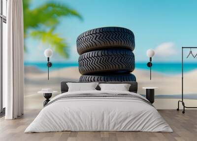 Three tires are stacked on top of each other on a sandy beach Wall mural