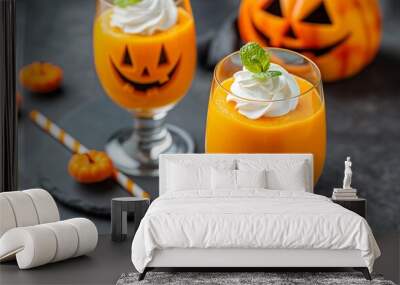 Two glasses of orange juice with whipped cream on top and a pumpkin decoration. Scene is festive and celebratory, as it is a Halloween-themed drink Wall mural