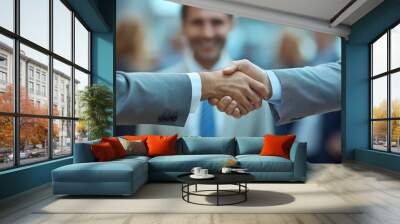 Two men shaking hands in front of a crowd. One of the men is wearing a tie. The other man is wearing a suit. Businessman Shaking Hands At Interview whit copy space Wall mural