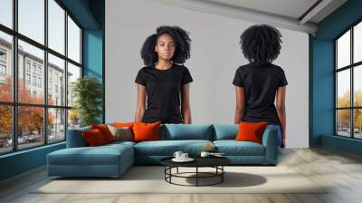 Two women are standing side by side, both wearing black t-shirts and blue jeans. The image is a close-up of their bodies. Scene is casual and relaxed. black woman t-shirt mock up front and back Wall mural