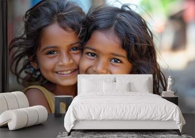 Two young indian girls are smiling and hugging each other. Scene is happy and warm. Two young asian girls smiling Wall mural