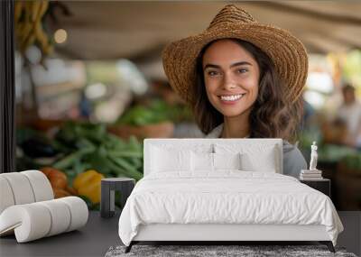 Woman wearing a straw hat stands in front of a vegetable stand. attractive female farmer standing proudly in front of her organic vegetable, fruit stand at the festival. Wall mural