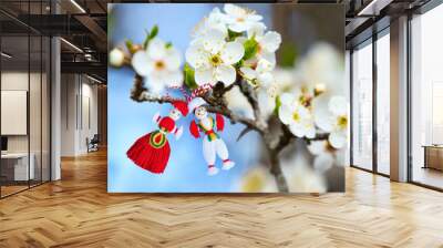 Bulgarian Martenitsa spring sign on blooming tree branch with flowers, holiday postcard background Wall mural