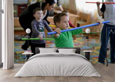 Children with disabilities do therapeutic gymnastics in a group for disabled children Wall mural