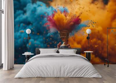 Hand holding golden trophy or cup award in vibrant explosion of powder. Success achievement concept. Champion reward. Competition or contest prize. Wall mural