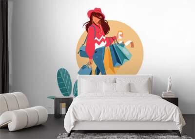 Young attractive fashionable woman holding packages with clothes after shopping. Wall mural