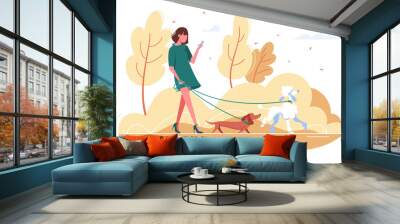 Young woman walks with dog through the woods. Wall mural