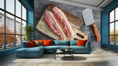 meat and knife
Two pieces of meat on a wooden board and a large knife lie on a gray stone background, top view close-up. Wall mural