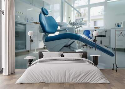 Modern dental practice. Dental chair and other accessories used by dentists in blue, medic light Wall mural