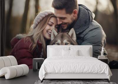 Portrait of a young beautiful couple of European appearance with a husky dog in the winter forest Wall mural