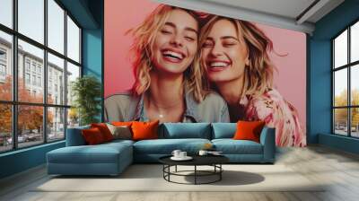 two happy stylish women in a concert, neutral background Wall mural