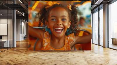 small little Girl at an amusement park with arms raised smiling Wall mural