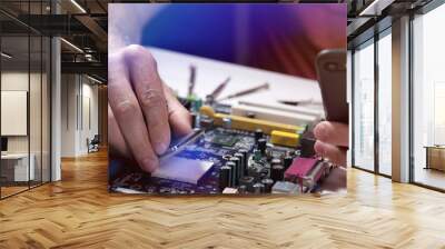 A technician repairs a motherboard in a service center. Computer Repair Wall mural