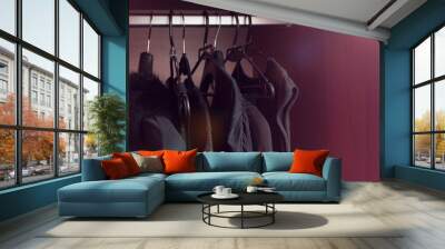 black clothes on hangers in the closet. Wall mural