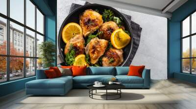 Chicken thighs with orange is a pan. Wall mural