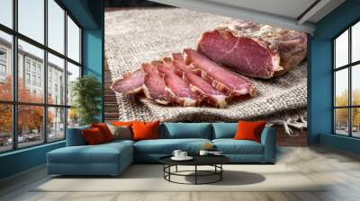 Dried pork meat on dark wooden background Wall mural