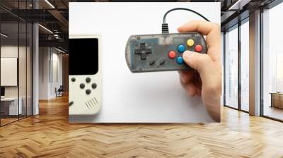 hand holding retro games isolated on a white background. focus on console and hands.  Wall mural