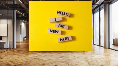 Hello I am new here symbol. Concept words Hello I am new here on wooden blocks. Beautiful yellow background. Business and Hello I am new here concept. Copy space. Wall mural