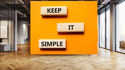 Keep it Simple symbol. Concept words Keep it Simple on wooden blocks. Beautiful orange background. Business and Keep it Simple concept. Copy space. Wall mural