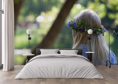 Little blond girl with the wreath of blue wild flowers. Back view. The celebration of Ivan Kupala (St. John Day). Old holiday dedicated to the summer solstice. Selective focus. Wall mural