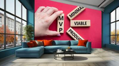 MVP - Most Valuable Player symbol. Wooden cubes with words MVP. Businessman hand. Beautiful red background. Business and MVP concept. Copy space. Wall mural