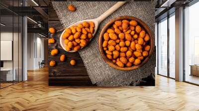 Paprika roasted peanuts on dark wooden background. Delicious snack peanut. Wall mural